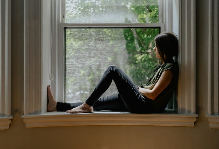 Woman looking out of window, wondering how to know what matters to you