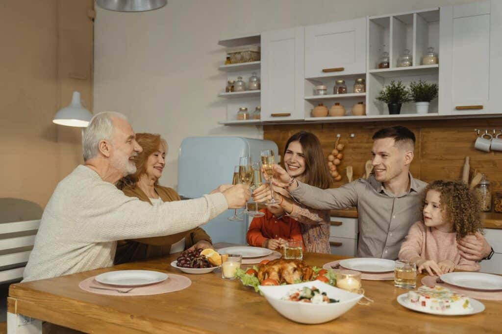 The family sharing dinner around a table representing connection and routines that support balance in life