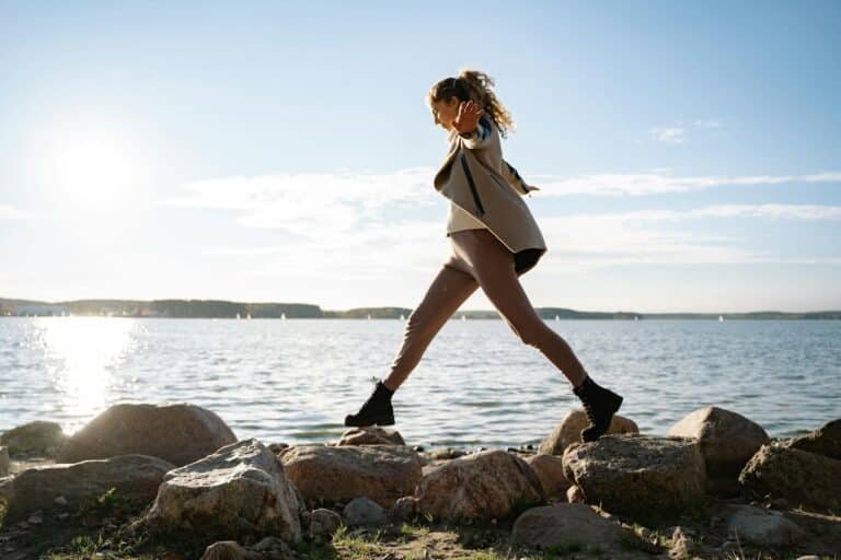 Woman balancing on rocks to represent living in balance