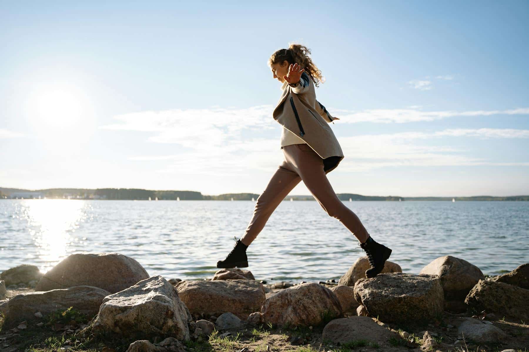 Woman balancing on rocks to represent living in balance