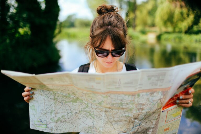 Woman looking at map illustrating how core values examples help you find direction in life.