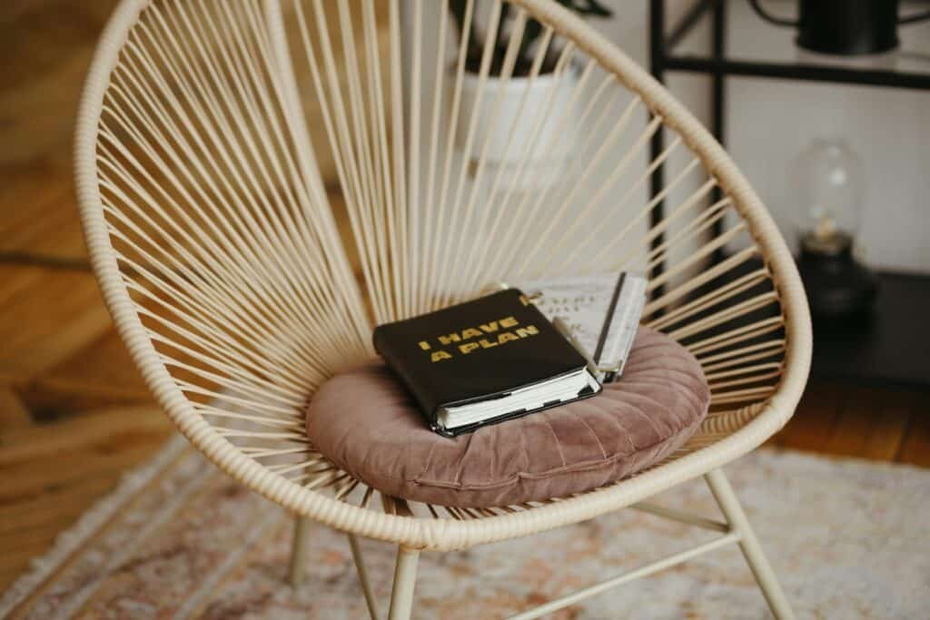 Photo of a chair with a cushion and and planner getting ready to reset your life 