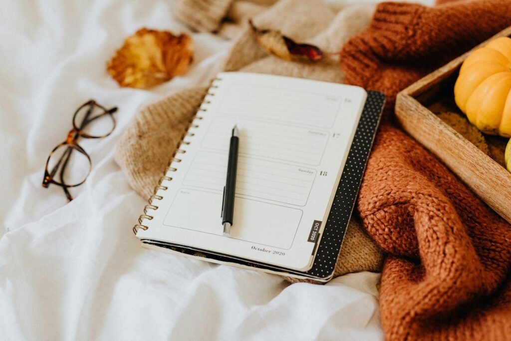 A photo of a planner in an  autumn scene preparing to reset your life for the coming season