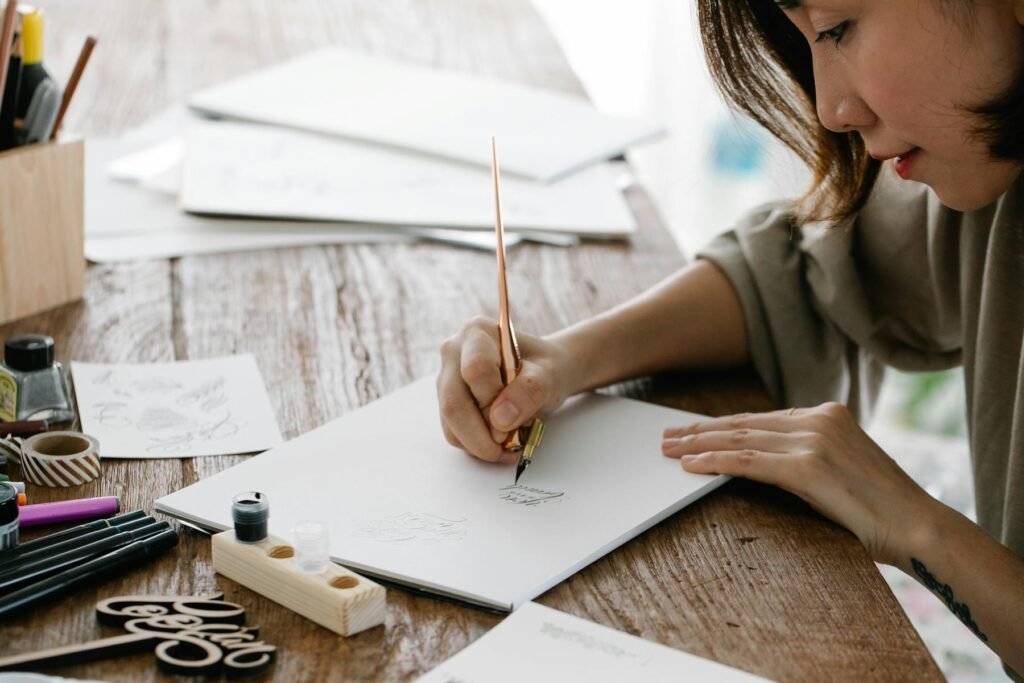 Woman practicing calligraphy, showing the mindful and creative benefits of having a hobby