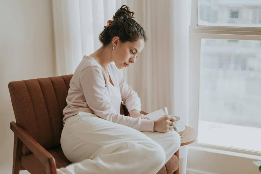 Woman journalling when life feels meaningless
