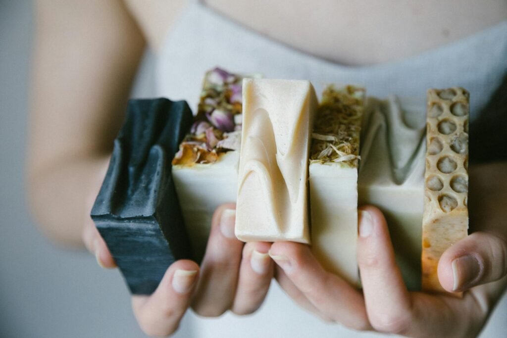 Handmade soaps in a woman's hands, demonstrating soap making is an example of skill based hobbies for women