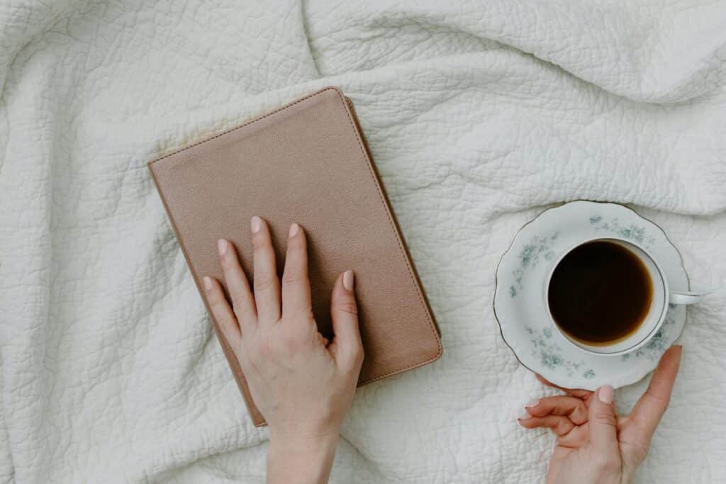 Calm moment with a closed book and coffee, representing self-reflection and choosing to be true to yourself and live authentically.