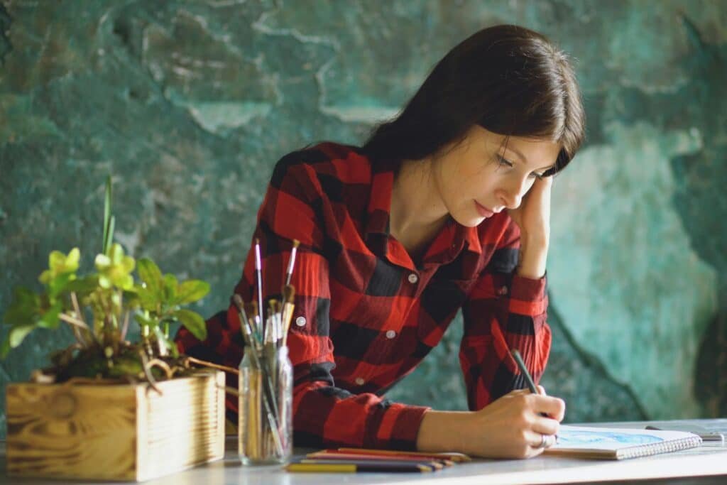 A woman drawing - one of her meaningful hobbies to help live intentionally